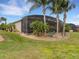 Landscaped backyard with screened patio and lush tropical plants at 296 Del Sol Ave, Davenport, FL 33837