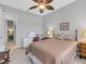 Bedroom with queen bed, ceiling fan, and access to hallway at 296 Del Sol Ave, Davenport, FL 33837
