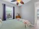 Bright bedroom with a queen-size bed, window, and ceiling fan at 296 Del Sol Ave, Davenport, FL 33837