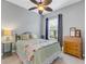 Charming bedroom with a full-size bed and ceiling fan at 296 Del Sol Ave, Davenport, FL 33837