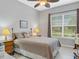 Bright bedroom with a queen-size bed and ceiling fan at 296 Del Sol Ave, Davenport, FL 33837