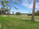 View of the golf course with a golfer and golf cart at 296 Del Sol Ave, Davenport, FL 33837