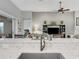 Modern kitchen with a stylish quartz countertop and a farmhouse sink at 296 Del Sol Ave, Davenport, FL 33837