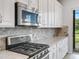 Modern kitchen with stainless steel appliances and quartz countertop at 296 Del Sol Ave, Davenport, FL 33837