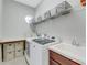 Laundry room with washer, dryer, shelving, and ample storage at 296 Del Sol Ave, Davenport, FL 33837