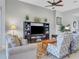 Living area with a large TV stand, comfortable seating and tiled floor at 296 Del Sol Ave, Davenport, FL 33837