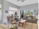 Living room with tiled floors, seating area, and view into kitchen area at 296 Del Sol Ave, Davenport, FL 33837