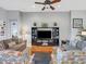 Bright living room with ample seating and a large TV at 296 Del Sol Ave, Davenport, FL 33837