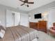 Main bedroom with king bed, dresser, chair, and access to the ensuite bathroom at 296 Del Sol Ave, Davenport, FL 33837