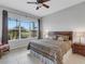 Spacious main bedroom with king-size bed and view of the golf course at 296 Del Sol Ave, Davenport, FL 33837