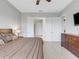 Main bedroom with king bed, dresser, and access to the ensuite bathroom at 296 Del Sol Ave, Davenport, FL 33837