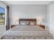 Main bedroom with king-size bed, nightstands, and large window with blinds at 296 Del Sol Ave, Davenport, FL 33837