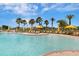 Relaxing pool area with plenty of lounge chairs and umbrellas at 296 Del Sol Ave, Davenport, FL 33837