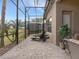 Spacious screened porch with lounge chairs, overlooking the backyard at 296 Del Sol Ave, Davenport, FL 33837