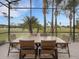 Enjoy dining alfresco on this screened porch overlooking the golf course at 296 Del Sol Ave, Davenport, FL 33837