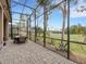 Extended screened patio with a dining area and beautiful golf course view at 296 Del Sol Ave, Davenport, FL 33837