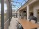 Large screened porch with dining and seating areas, plus a grill at 296 Del Sol Ave, Davenport, FL 33837