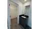 Bathroom with dark vanity, walk-in closet, and grey flooring at 3237 Energy Drive, Kissimmee, FL 34747