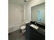 Clean bathroom with dark vanity, white tile, and a bathtub at 3237 Energy Drive, Kissimmee, FL 34747