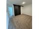 Second bedroom with dark sliding doors and carpet at 3237 Energy Drive, Kissimmee, FL 34747