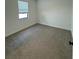 Simple bedroom with neutral colored walls and carpet flooring at 3237 Energy Drive, Kissimmee, FL 34747
