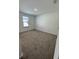 Spacious carpeted bedroom with large window and neutral walls at 3237 Energy Drive, Kissimmee, FL 34747