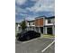 Modern townhome exterior with dark gray and brown accents at 3237 Energy Drive, Kissimmee, FL 34747