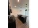 Modern kitchen with dark cabinetry, granite island, and pendant lights at 3237 Energy Drive, Kissimmee, FL 34747