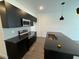 Modern kitchen features dark cabinetry, geometric backsplash, and stainless steel appliances at 3237 Energy Drive, Kissimmee, FL 34747