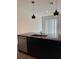 Modern kitchen with dark cabinetry, granite island, and pendant lights at 3237 Energy Drive, Kissimmee, FL 34747