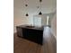Modern kitchen with island, stainless steel appliances, and dark cabinetry at 3237 Energy Drive, Kissimmee, FL 34747
