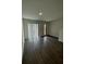 Open living room featuring vinyl plank flooring and sliding glass doors at 3237 Energy Drive, Kissimmee, FL 34747