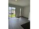 Living room with gray vinyl flooring and an exterior view at 3237 Energy Drive, Kissimmee, FL 34747