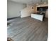 Open living area with grey vinyl flooring and stairs to upper level at 3237 Energy Drive, Kissimmee, FL 34747