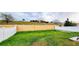 Grass backyard with white and tan fences at 421 Disa Dr, Davenport, FL 33837
