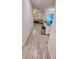 View down a long hallway, showing wood-look tile floors and access to living areas at 421 Disa Dr, Davenport, FL 33837