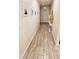 Long hallway with wood-look tile flooring and framed photos at 421 Disa Dr, Davenport, FL 33837