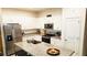 Modern kitchen with white cabinets, granite countertops, and stainless steel appliances at 421 Disa Dr, Davenport, FL 33837