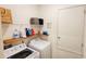Bright laundry room with washer, dryer, and shelving at 421 Disa Dr, Davenport, FL 33837