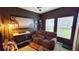 Relaxing media room, featuring a couch, keyboard, and large wall art at 421 Disa Dr, Davenport, FL 33837