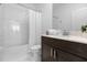 Clean bathroom with tub shower combo and dark vanity at 4370 Rhyme St, Kissimmee, FL 34746