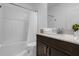 Clean bathroom with shower/tub combo and dark vanity at 4370 Rhyme St, Kissimmee, FL 34746