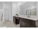 Clean bathroom with dark brown vanity and white countertops at 4370 Rhyme St, Kissimmee, FL 34746