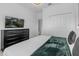 Main bedroom with king-size bed, large TV, and ample closet space at 4370 Rhyme St, Kissimmee, FL 34746