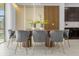 Modern dining room with oval wood table and gray velvet chairs at 4370 Rhyme St, Kissimmee, FL 34746