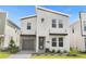 Modern two-story house with gray garage door and stone accents at 4370 Rhyme St, Kissimmee, FL 34746