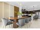 Open concept kitchen and dining area with modern cabinetry and breakfast bar at 4370 Rhyme St, Kissimmee, FL 34746