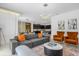 Open living room showcasing a gray sectional and a view into the dining area at 4370 Rhyme St, Kissimmee, FL 34746