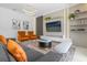 Living room featuring a large TV, comfortable seating, and stylish decor at 4370 Rhyme St, Kissimmee, FL 34746
