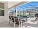 Outdoor patio with table and chairs, overlooking the pool and spa at 4370 Rhyme St, Kissimmee, FL 34746